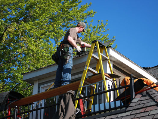Roofer working on residential home